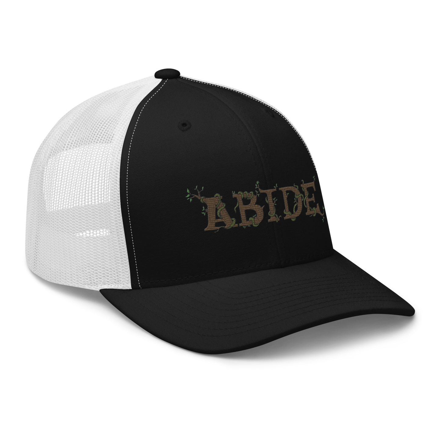 Black trucker hat with white mesh with the letters Abide on the front. The letters are in brown with green vines wrapped around. The Abide is embroidered on the hat.