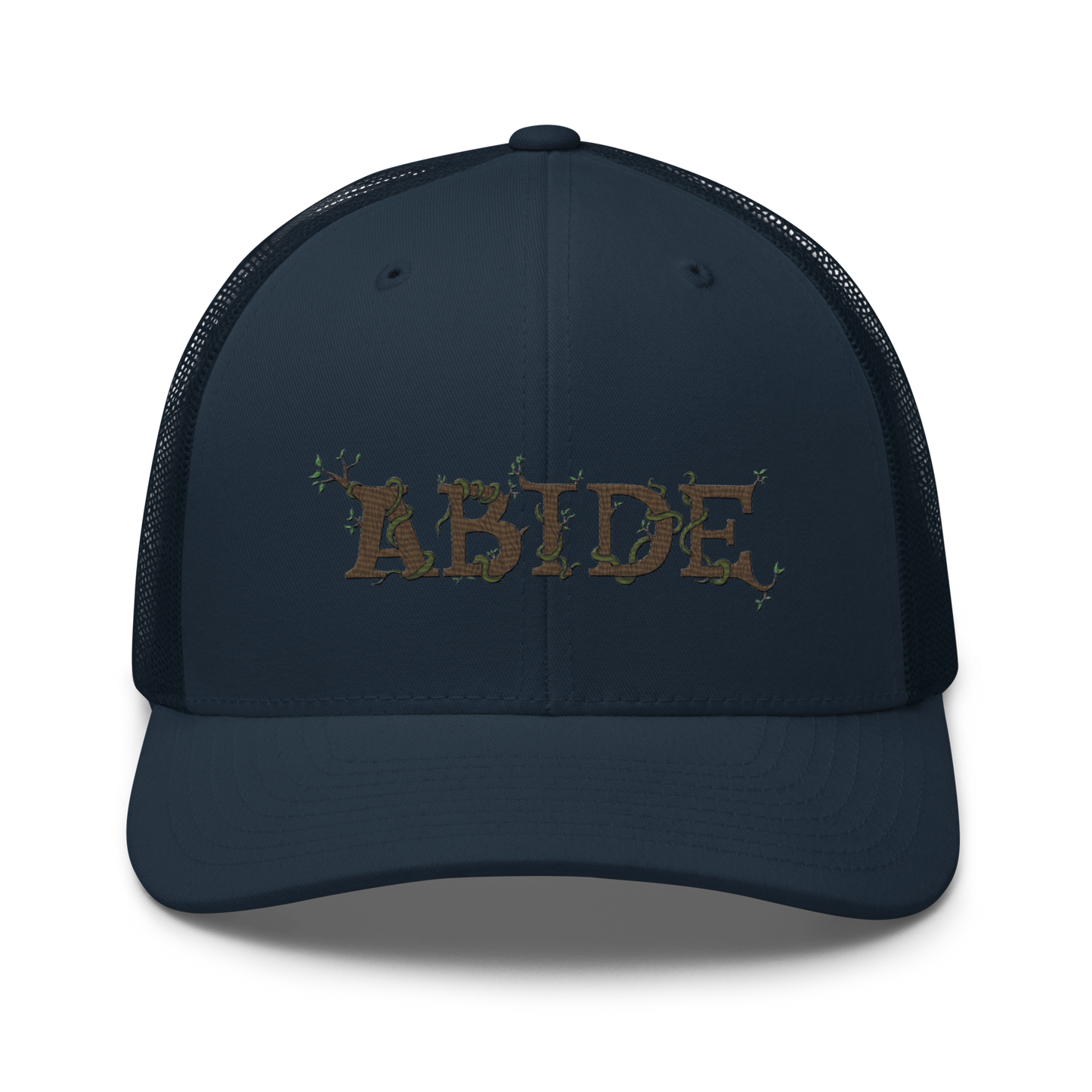 Navy blue trucker hat with the letters Abide on the front. The letters are in brown with green vines wrapped around. The Abide is embroidered on the hat.