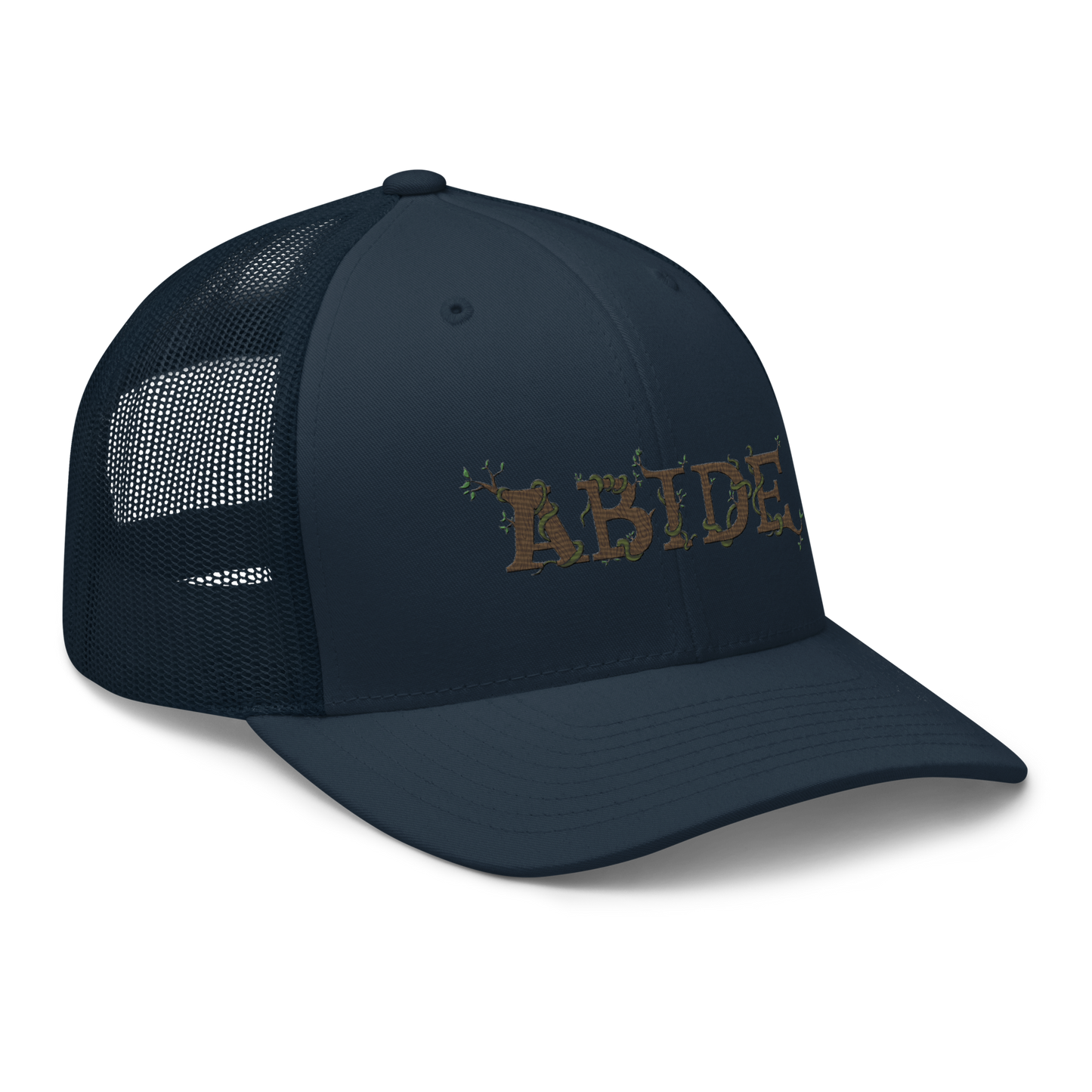 Navy blue trucker hat with the letters Abide on the front. The letters are in brown with green vines wrapped around. The Abide is embroidered on the hat.